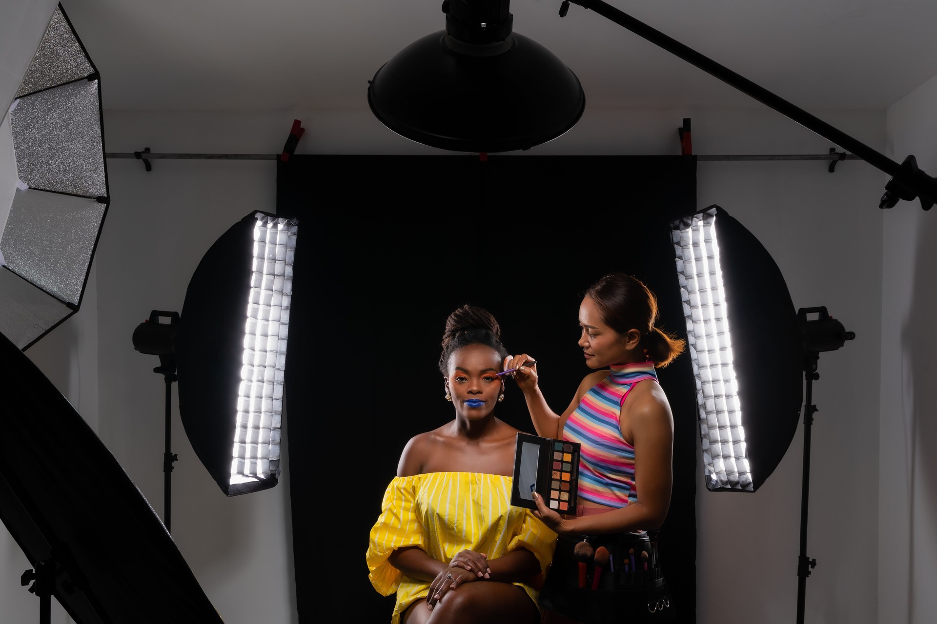 Professional makeup artist working with fashion model.
